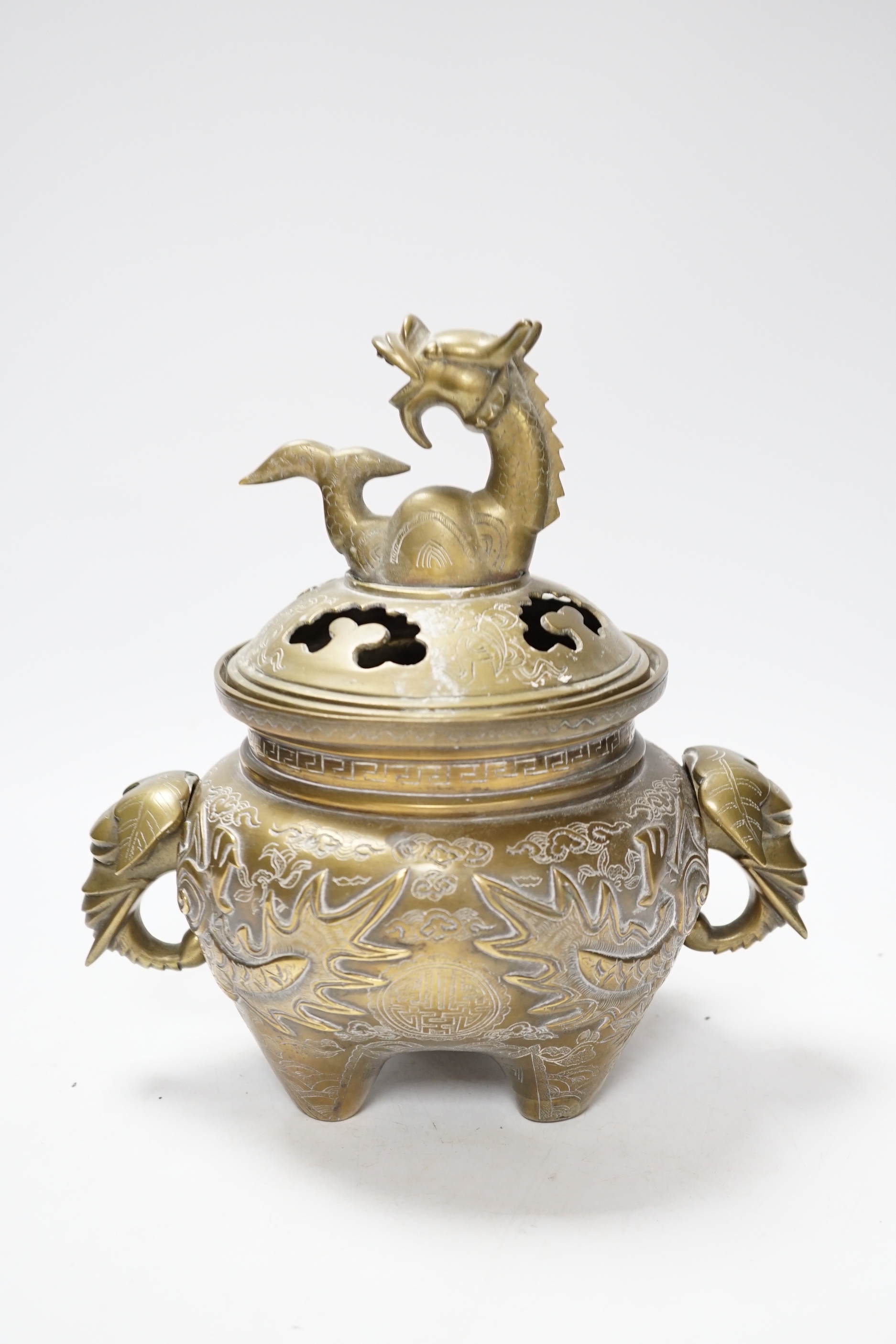 A Chinese bronze ‘dragon’ tripod censer and cover, 24cm